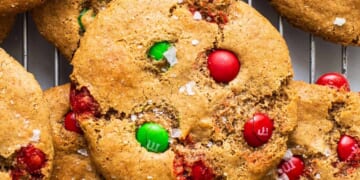 Christmas cookies with m&ms on a cooling rack.