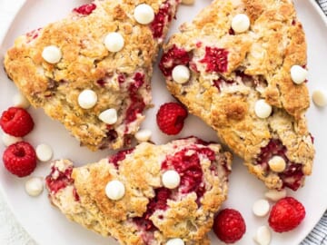 Raspberry and white chocolate scones on a plate.