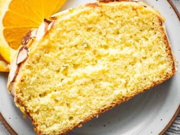 A slice of orange pound cake on a plate.