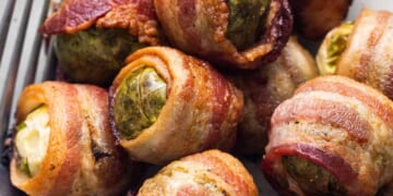 Bacon wrapped brussels sprouts on a plate.