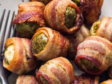 Bacon wrapped brussels sprouts on a plate.