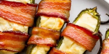 Bacon wrapped jalapenos on a plate.