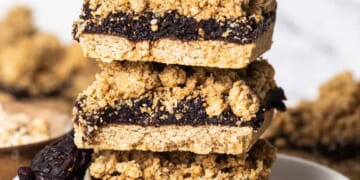 A stack of fig bars on a plate.