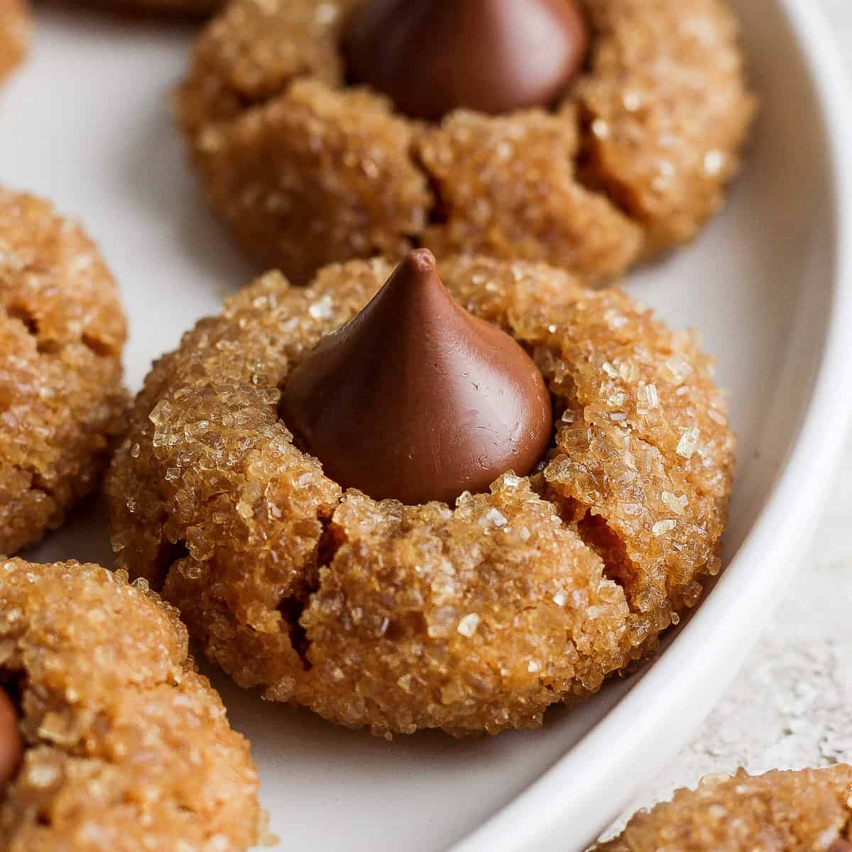 Peanut butter cookies with chocolate kisses on a plate.