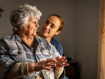 photo of woman comforting senior mother