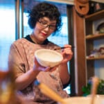 photo of woman painting pottery