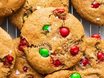 Christmas cookies with m&ms on a cooling rack.