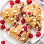 Raspberry and white chocolate scones on a plate.