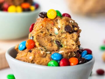 A bowl filled with cookies and m&m's.