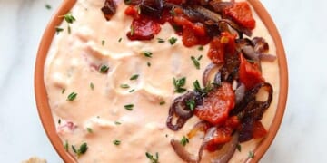 a skinny roasted red pepper and goat cheese dip with bread.