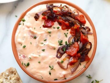 a skinny roasted red pepper and goat cheese dip with bread.