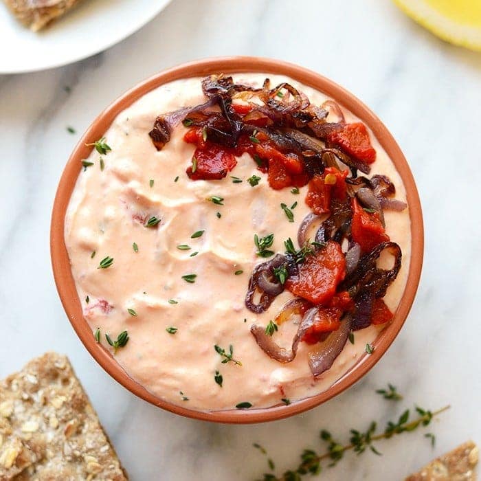 a skinny roasted red pepper and goat cheese dip with bread.