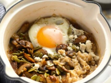 a bowl of oatmeal with a fried egg on top.