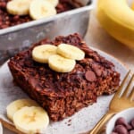 A plate of chocolate banana granola with banana slices on it.