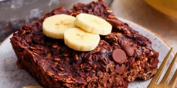 A plate of chocolate banana granola with banana slices on it.