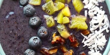 Blueberry Smoothie Bowl filled with blueberry, coconut, and kiwi smoothie.