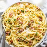 A bowl of spaghetti with bacon and parmesan.