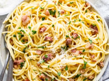 A bowl of spaghetti with bacon and parmesan.