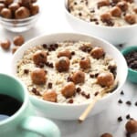 A bowl of Chocolate Chip Cookie Dough Oatmeal accompanied by a cup of coffee.