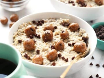 A bowl of Chocolate Chip Cookie Dough Oatmeal accompanied by a cup of coffee.