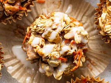 A group of muffins with granola and carrots.