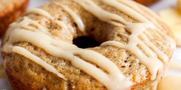 A banana-flavored donut with a glaze topping on a white background.