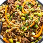 A bowl of noodles with meat and vegetables.