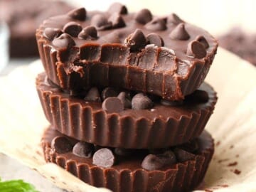 three almond butter cups stacked on top of each other with mint leaves.