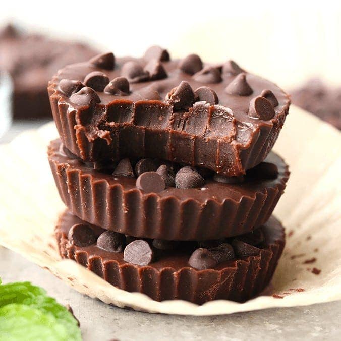 three almond butter cups stacked on top of each other with mint leaves.