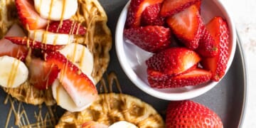 Waffles with strawberries, peanut butter and bananas.