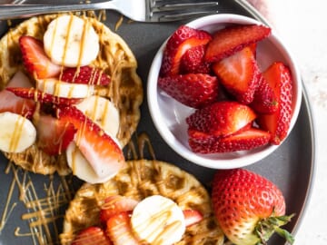 Waffles with strawberries, peanut butter and bananas.